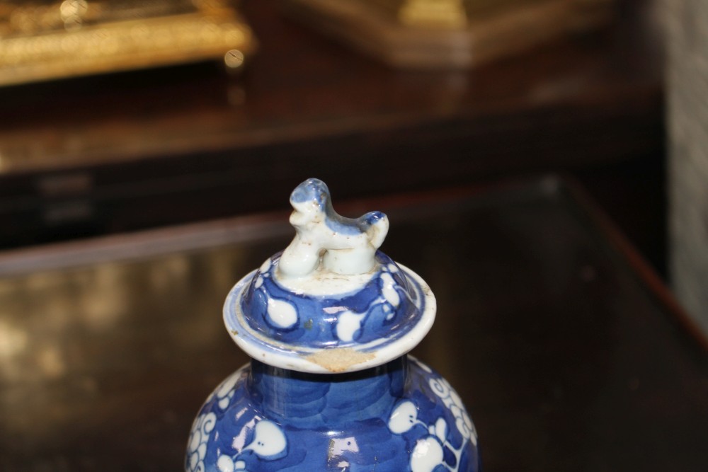 An 18th century Chinese export teapot and a pair of prunus pattern vases and covers